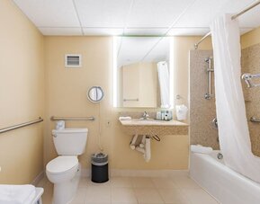 Private guest bathroom with combined shower and tub at Wyndham Omaha.