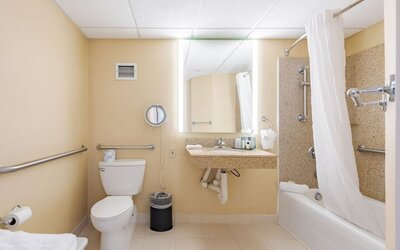 Private guest bathroom with combined shower and tub at Wyndham Omaha.