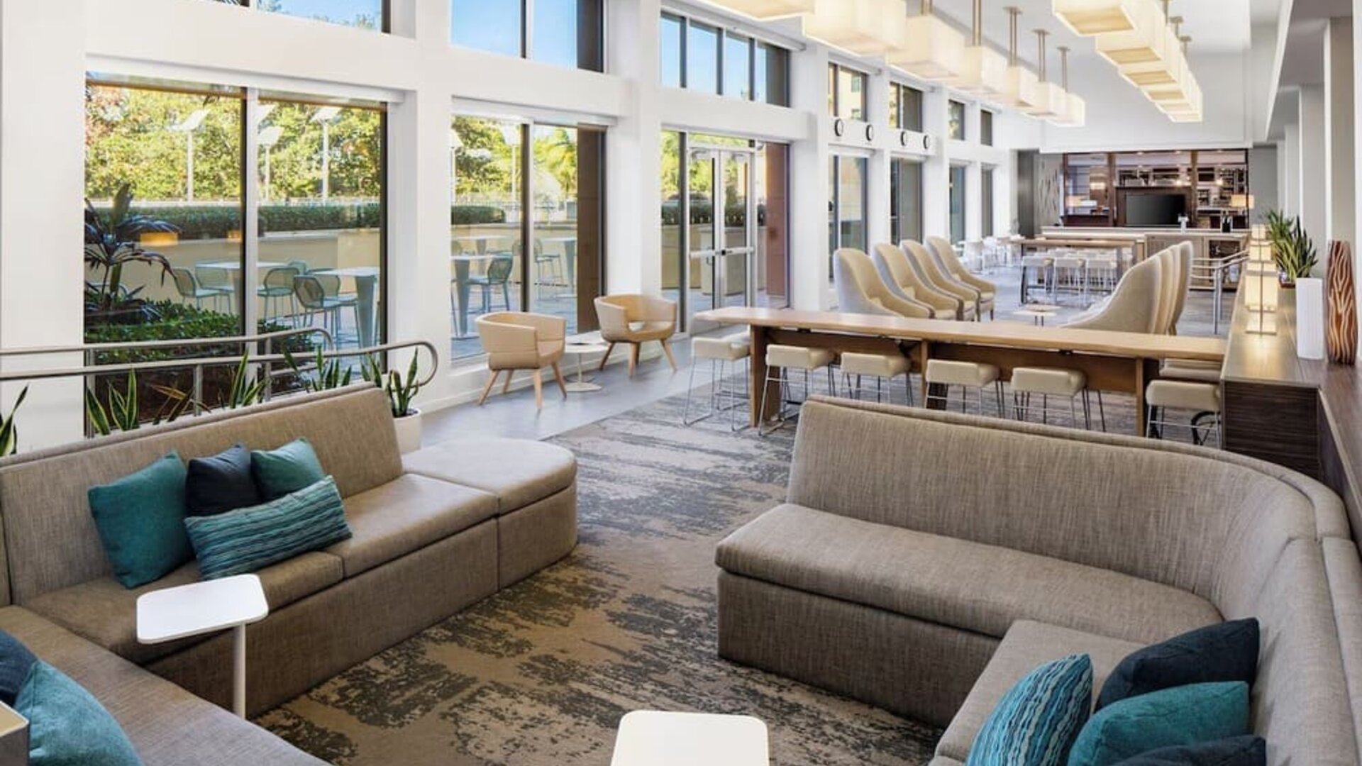 Lobby lounge seating and workspace at Element Miami International Airport.