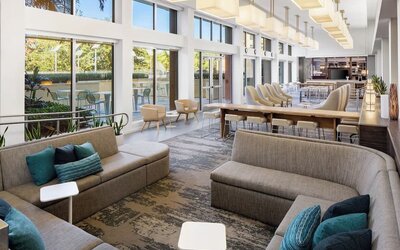 Lobby lounge seating and workspace at Element Miami International Airport.