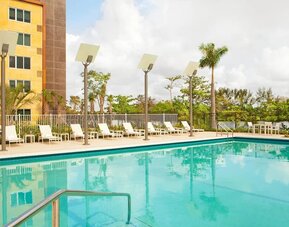Outdoor pool with lounge chairs at Element Miami International Airport.