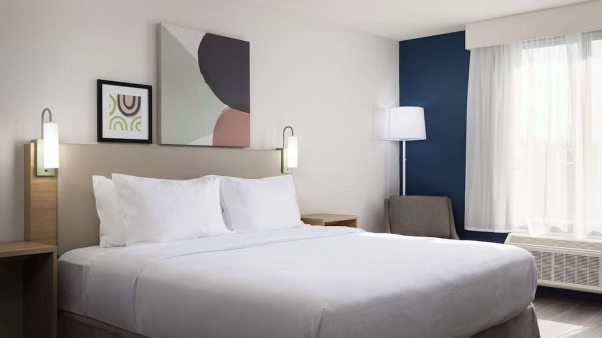 Day use room with king bed and tv at Spark By Hilton Guelph.