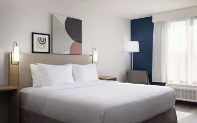 Day use room with king bed and tv at Spark By Hilton Guelph.