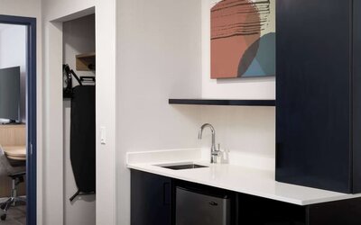 Kitchen and mini-fridge at Spark By Hilton Guelph.