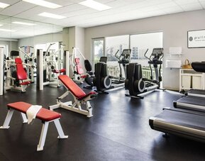 Fitness center with natural light at Pullman Miami Airport.
