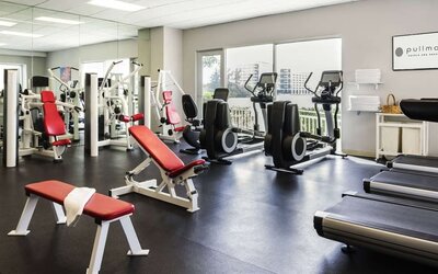 Fitness center with natural light at Pullman Miami Airport.
