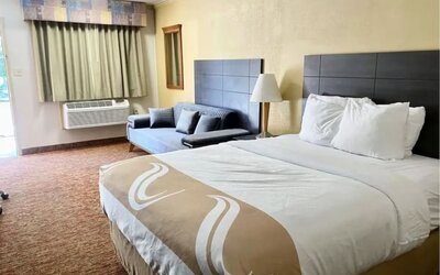 King bed with AC at Hibiscus Inn & Suites.