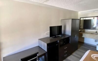 Desk and TV at Hibiscus Inn & Suites.