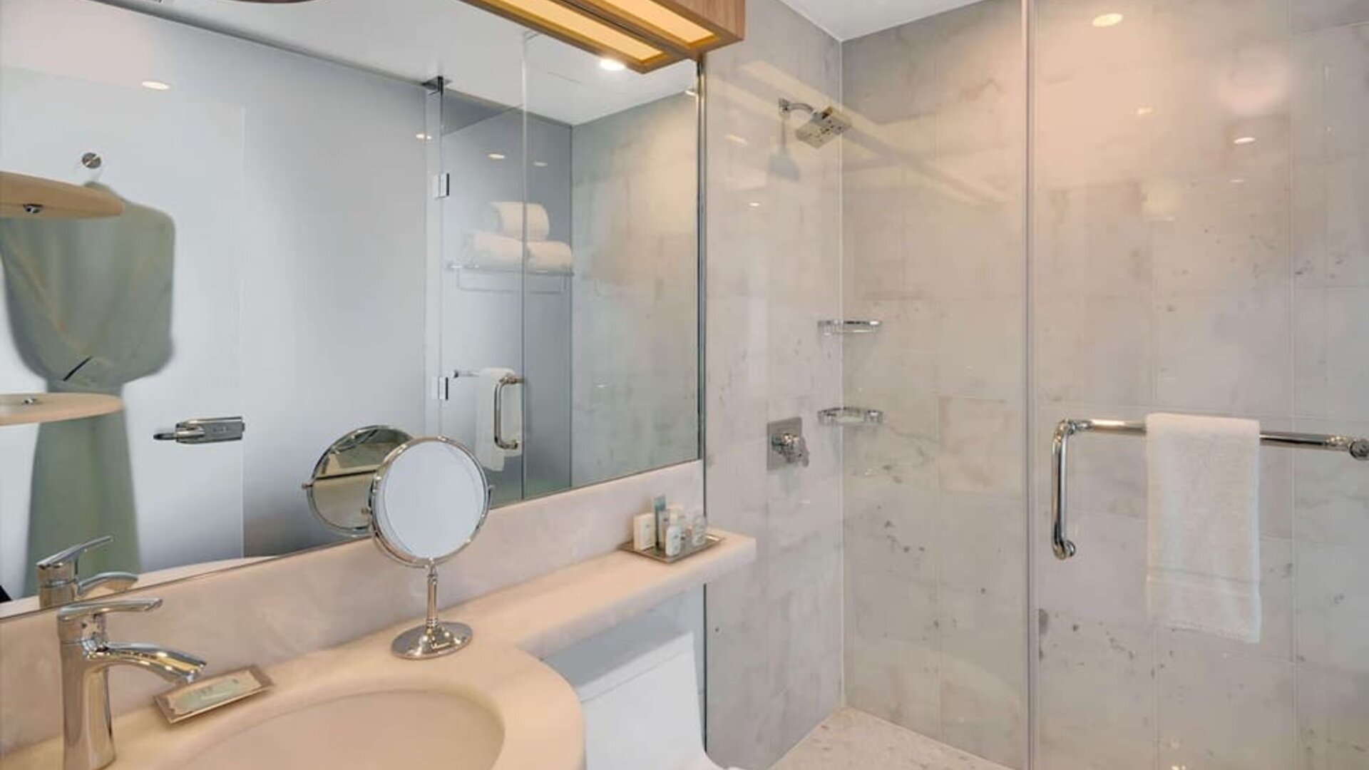 Private guest bathroom with shower and free toiletries at Wyndham Garden Brooklyn Sunset Park.