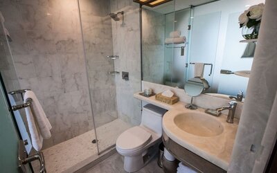 Private guest bathroom with shower and free toiletries at Wyndham Garden Brooklyn Sunset Park.