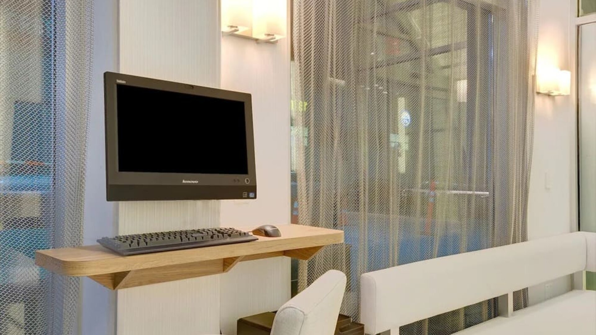 Business center with computer, printer and comfortable seating at Wyndham Garden Brooklyn Sunset Park.