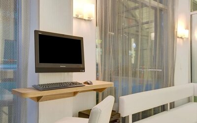 Business center with computer, printer and comfortable seating at Wyndham Garden Brooklyn Sunset Park.