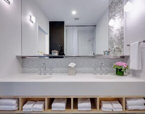 Private guest bathroom with shower and free toiletries at Nu Hotel - Brooklyn.