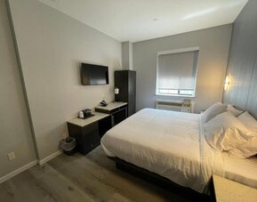 Standard room with king bed and workspace at King Hotel Brooklyn.