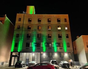 Exterior of King Hotel Brooklyn and parking area,