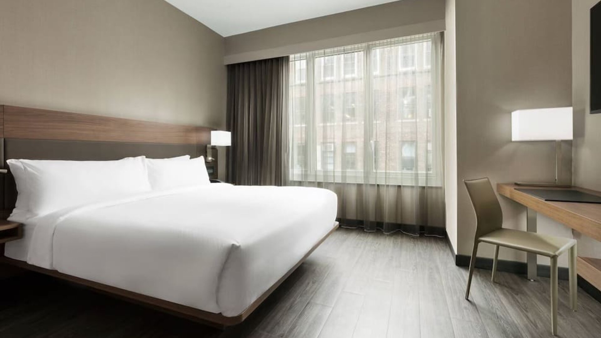 Standard day use room with king bed, large windows, work desk and private bathroom at AC Hotel New York Times Square.