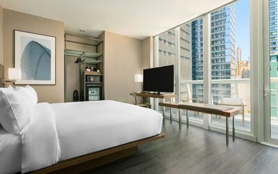 Day use room with work desk, balcony and private bathroom at AC Hotel New York Times Square.