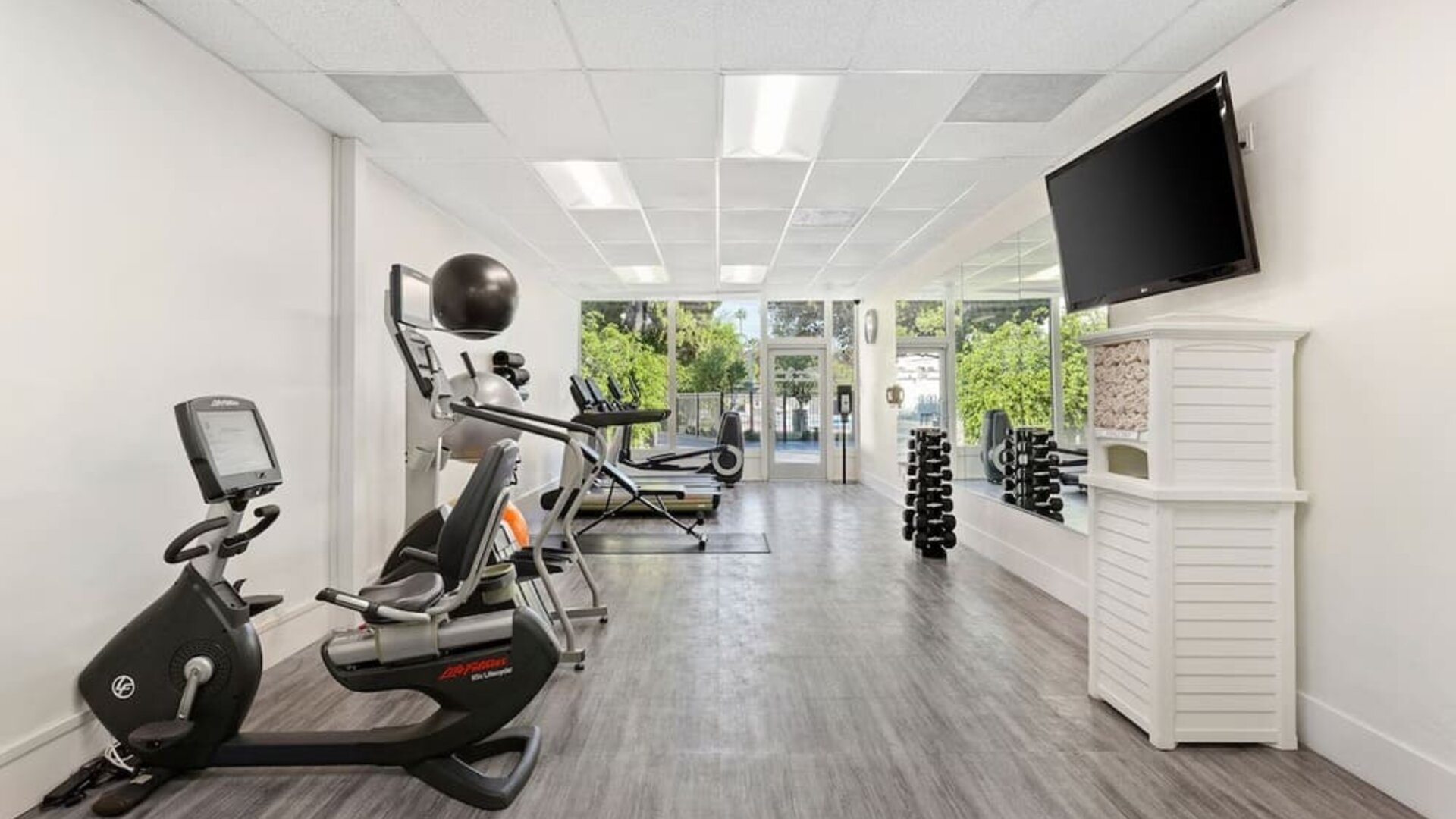 Fitness center with natural light at The Anaheim Hotel.