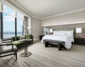 Comfortable king bedroom and a view of the river at The Westin New Orleans.