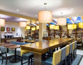 On-site restaurant with comfortable seating, perfect as workspace at Hampton Inn Manhattan - Madison Square Garden.
