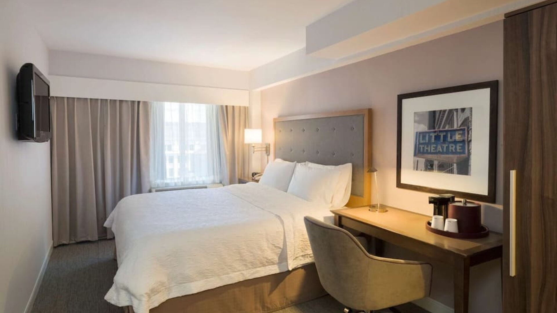 Day use room with king bed, work desk, natural light and private bathroom at Hampton Inn Manhattan - Madison Square Garden.