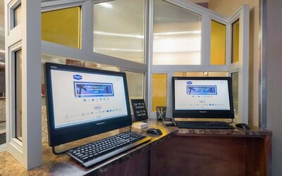 Business center with computers and printer at Hampton Inn Manhattan - Madison Square Garden.