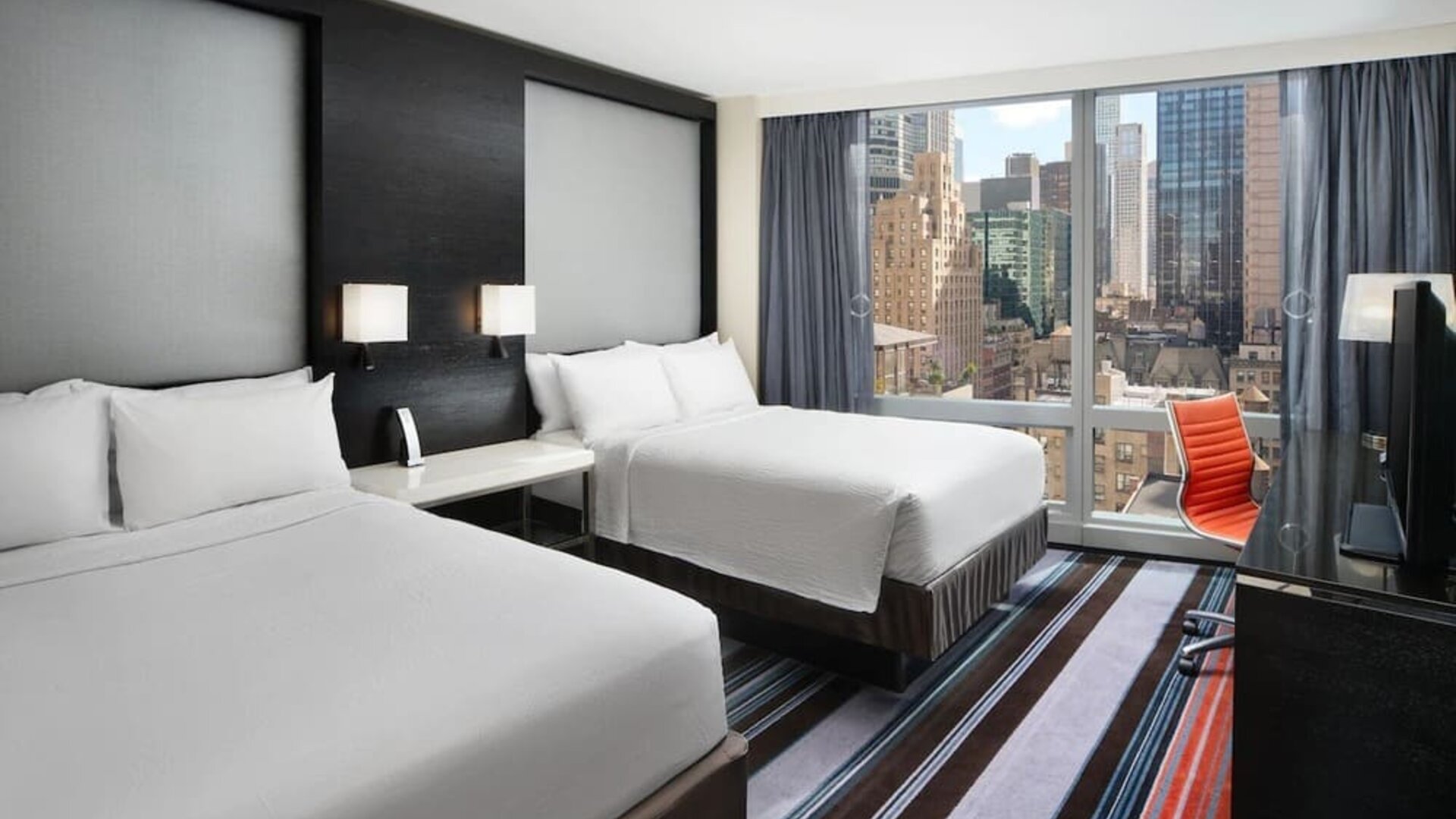 Day use twin room with work desk and floor to ceiling window at Courtyard By Marriott New York Manhattan/Central Park.
