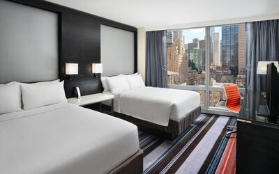 Day use twin room with work desk and floor to ceiling window at Courtyard By Marriott New York Manhattan/Central Park.