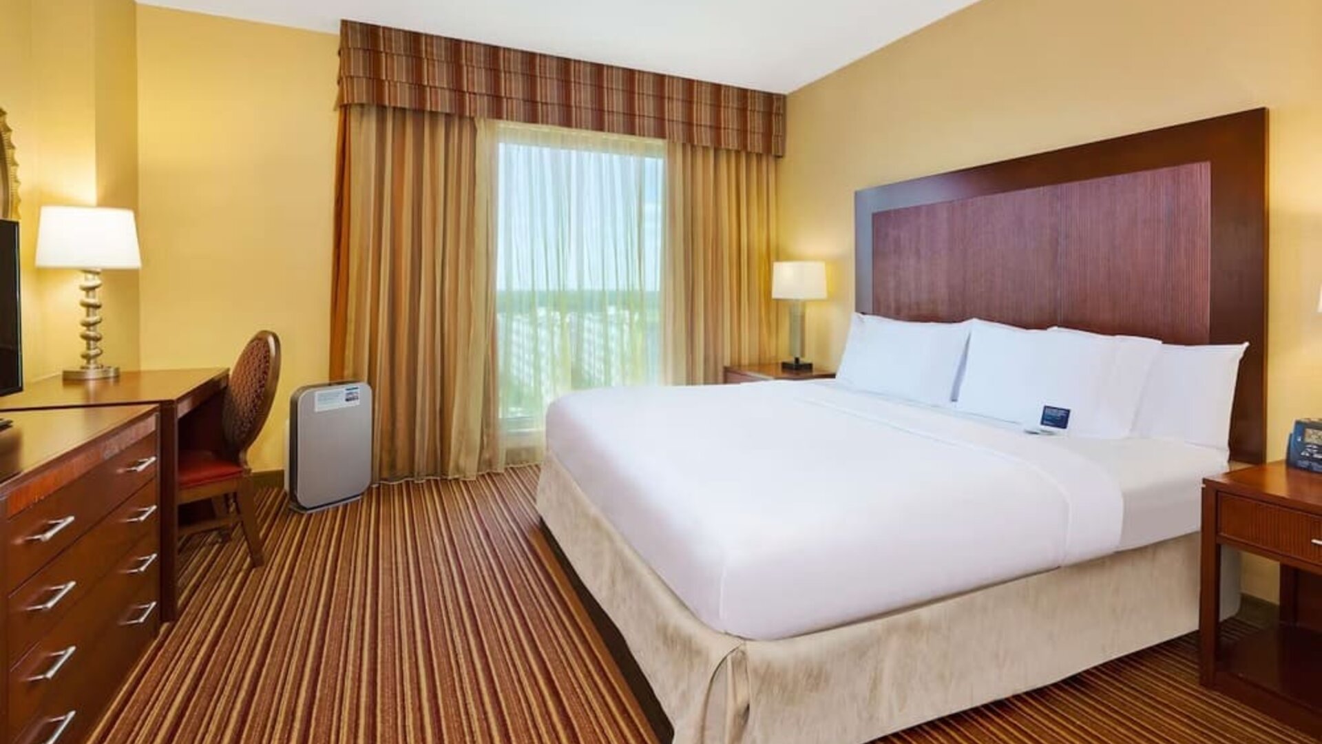 Day use room with work desk and natural light at Embassy Suites By Hilton Charlotte-Concord-Golf Resort & Spa.