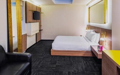 King room with workspace, lounge seating and private bathroom at Hotel Shocard NYC.