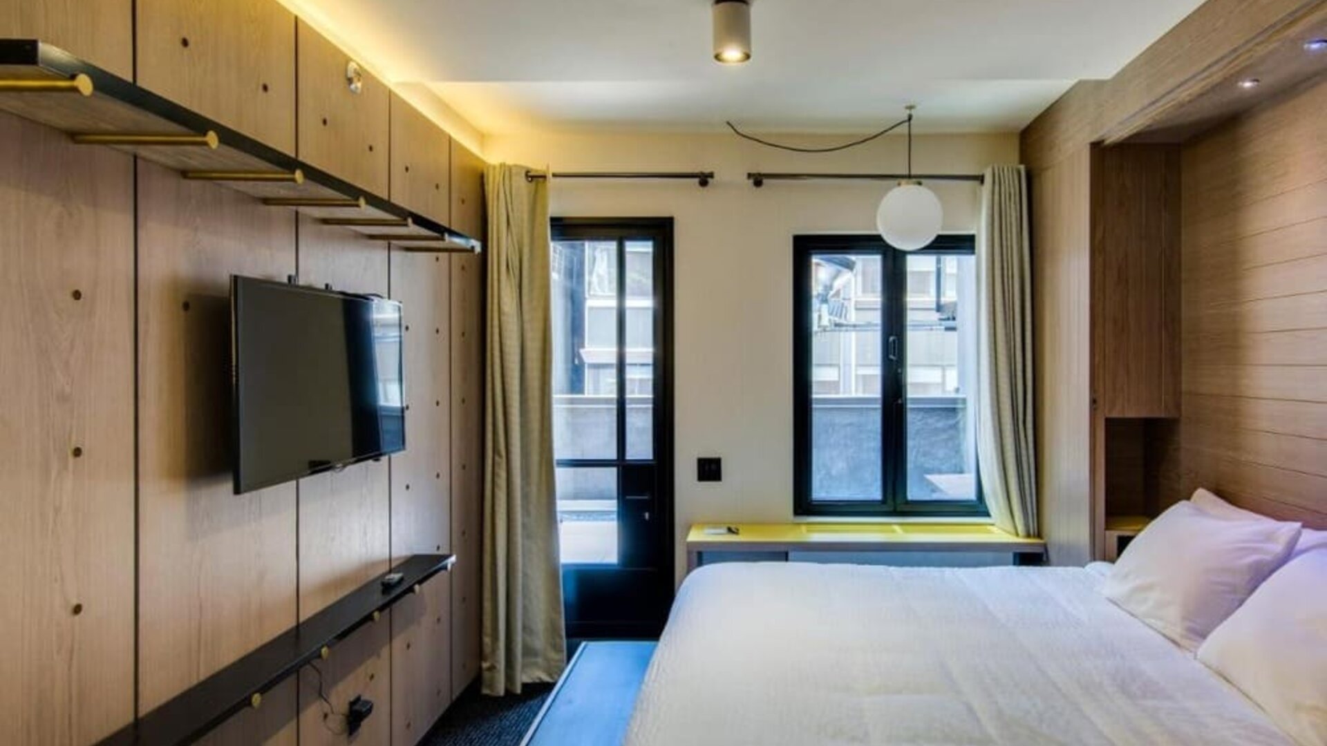 King room with large windows, work desk and private bathroom at Hotel Shocard NYC.