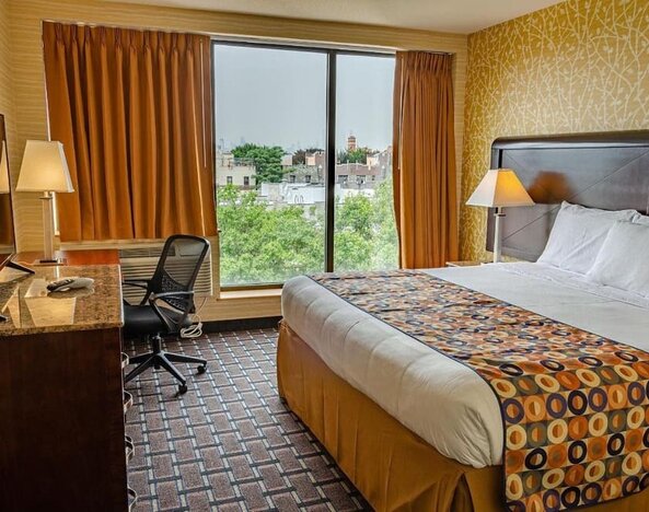 Day use room with king bed, work desk, large windows and private bathroom at Elmhurst Hotel.
