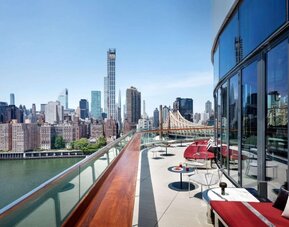 Rooftop terrace with comfortable seating and city view at Graduate New York.