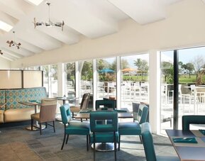 On-site restaurant with comfortable seating, perfect for co-working at Sheraton Miami Airport Hotel.