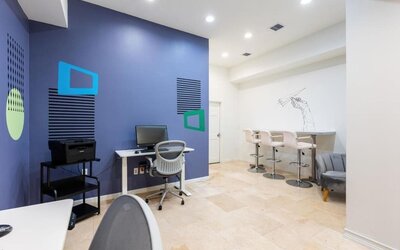 Business center with computers, printer and ergonomic chairs at Regency Miami Airport By Sonesta.