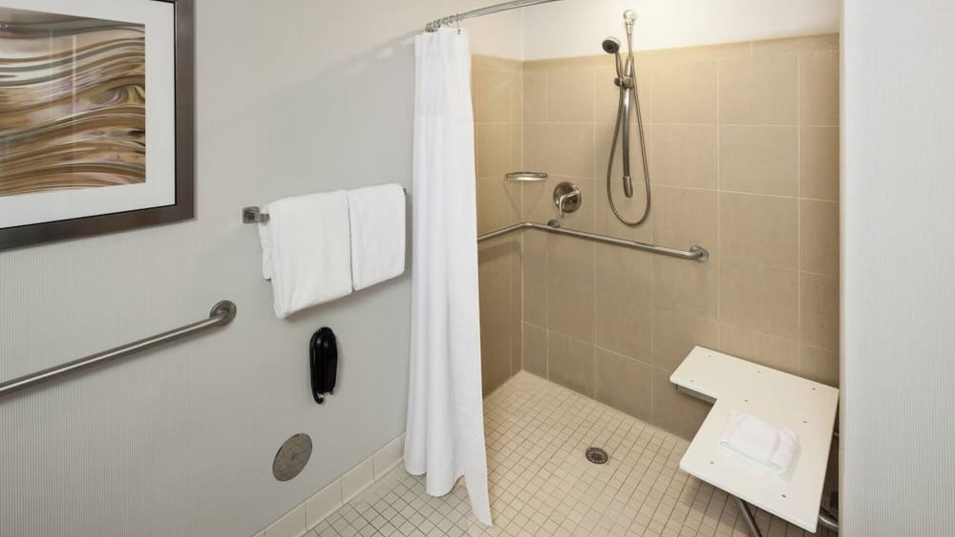 Private guest bathroom with accesible shower and free toiletries at Courtyard Miami Dolphin Mall.