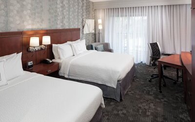 Day use twin room with large windows, work desk and private bathroom at Courtyard Miami Dolphin Mall.