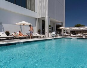 Outdoor pool with lounge chairs at EB Hotel Miami.