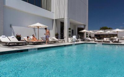 Outdoor pool with lounge chairs at EB Hotel Miami.
