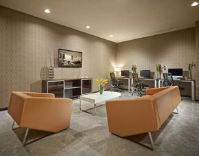 Business center with computers,ergonomic chairs and lounge area at EB Hotel Miami.