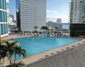 Rooftop pool with lounge chairs at Hyatt Centric Brickell Miami.