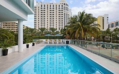 Outdoor pool with lounge seating at Hyatt Centric Miami South Beach.
