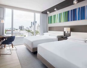 Day use twin room with floor to ceiling windows, work desk and private bathroom at Hyatt Centric Miami South Beach.