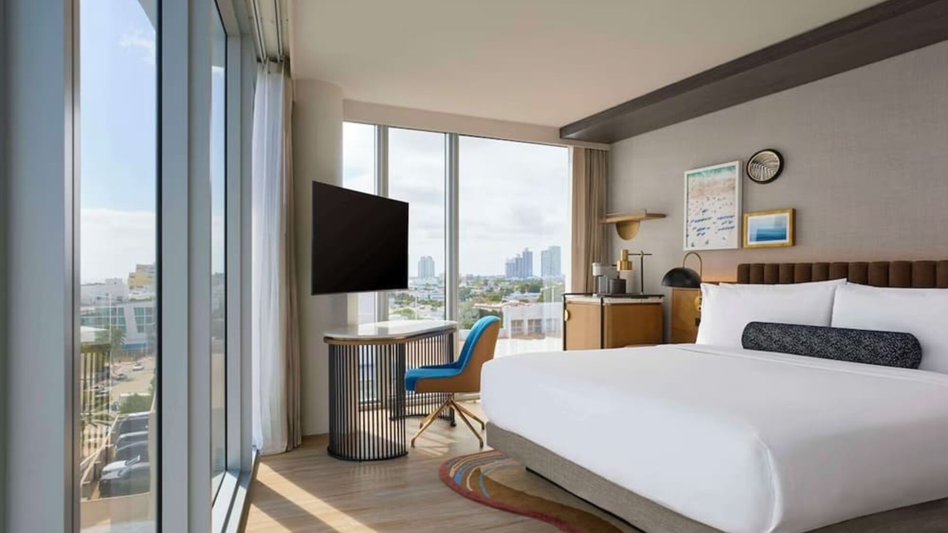 King room with floor to ceiling windows, work desk, TV screen and private bathroom at Hyatt Centric Miami South Beach.
