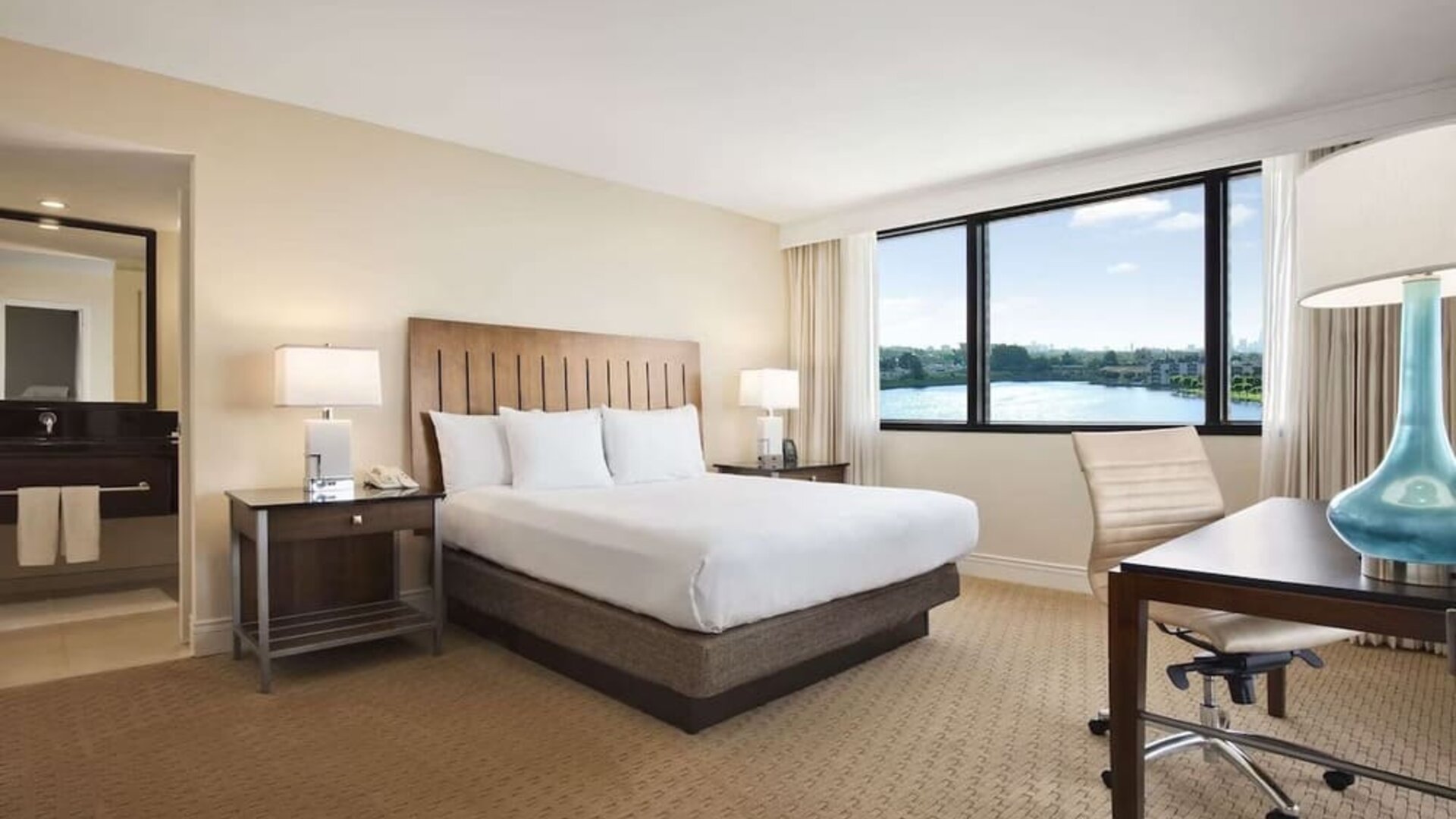 Day use room with large windows, work desk and private bathroom at Hilton Miami Airport Blue Lagoon.