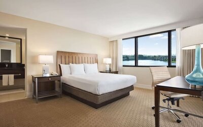 Day use room with large windows, work desk and private bathroom at Hilton Miami Airport Blue Lagoon.