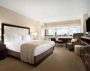 Day use room with work desk, TV screen, private bathroom and large windows at Hilton Miami Airport Blue Lagoon.