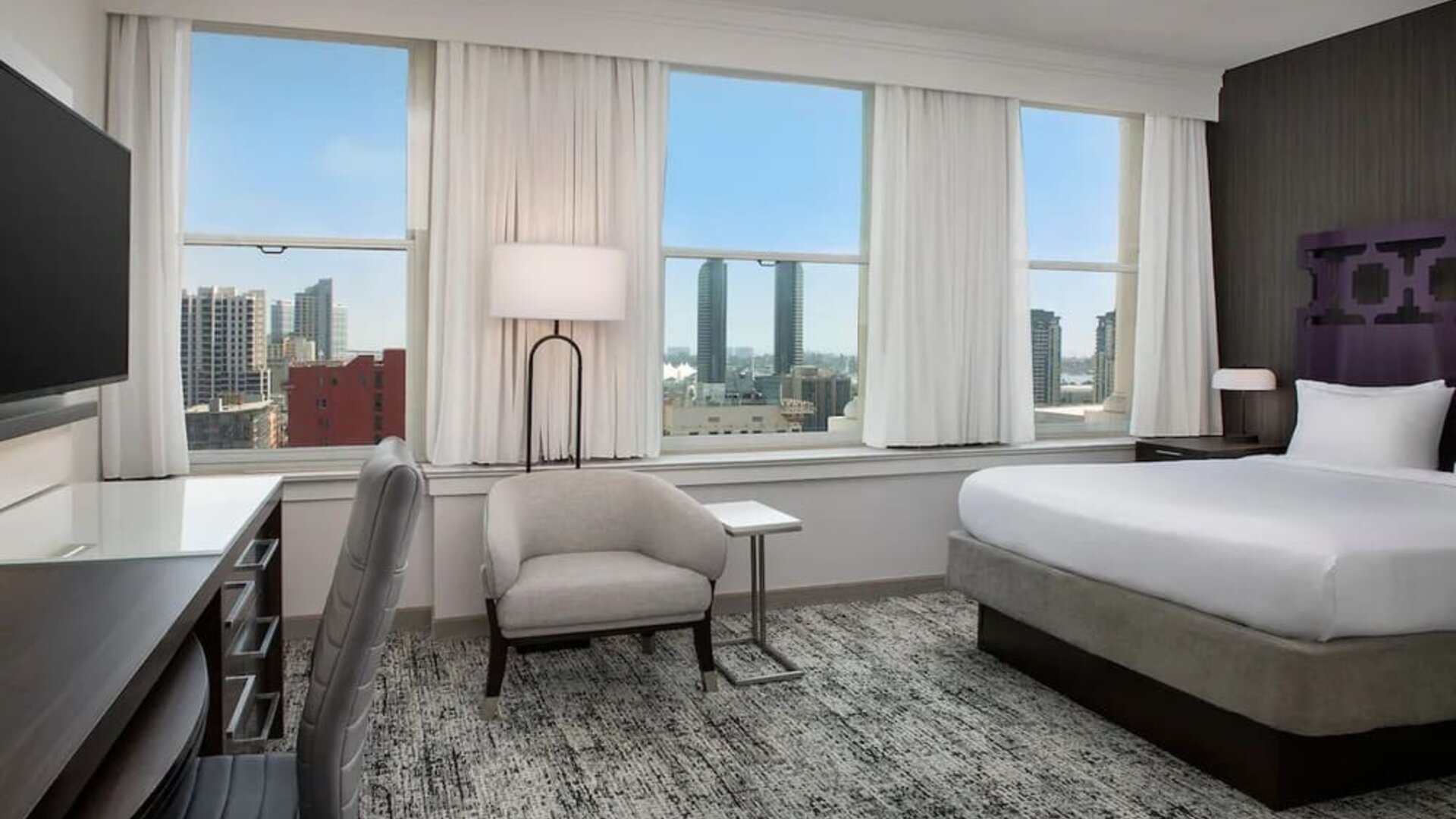 Spacious day use room with work desk and natural light at Courtyard San Diego Downtown.