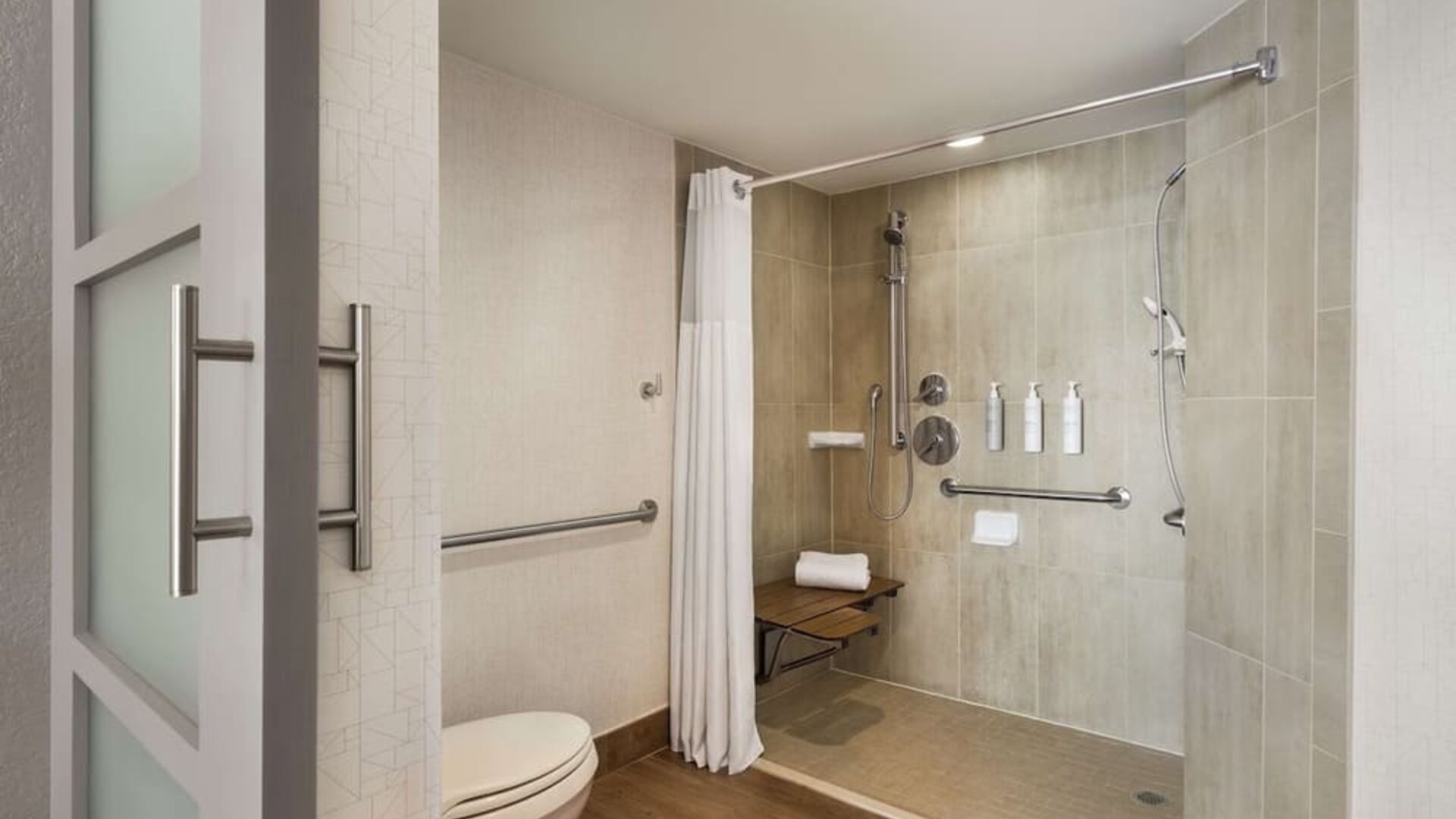 Private guest bathroom with shower and free toiletries at Embassy Suites By Hilton Miami - International Airport.