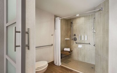 Private guest bathroom with shower and free toiletries at Embassy Suites By Hilton Miami - International Airport.